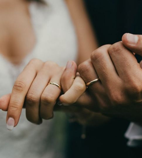 Newlywed couple showing wedding rings